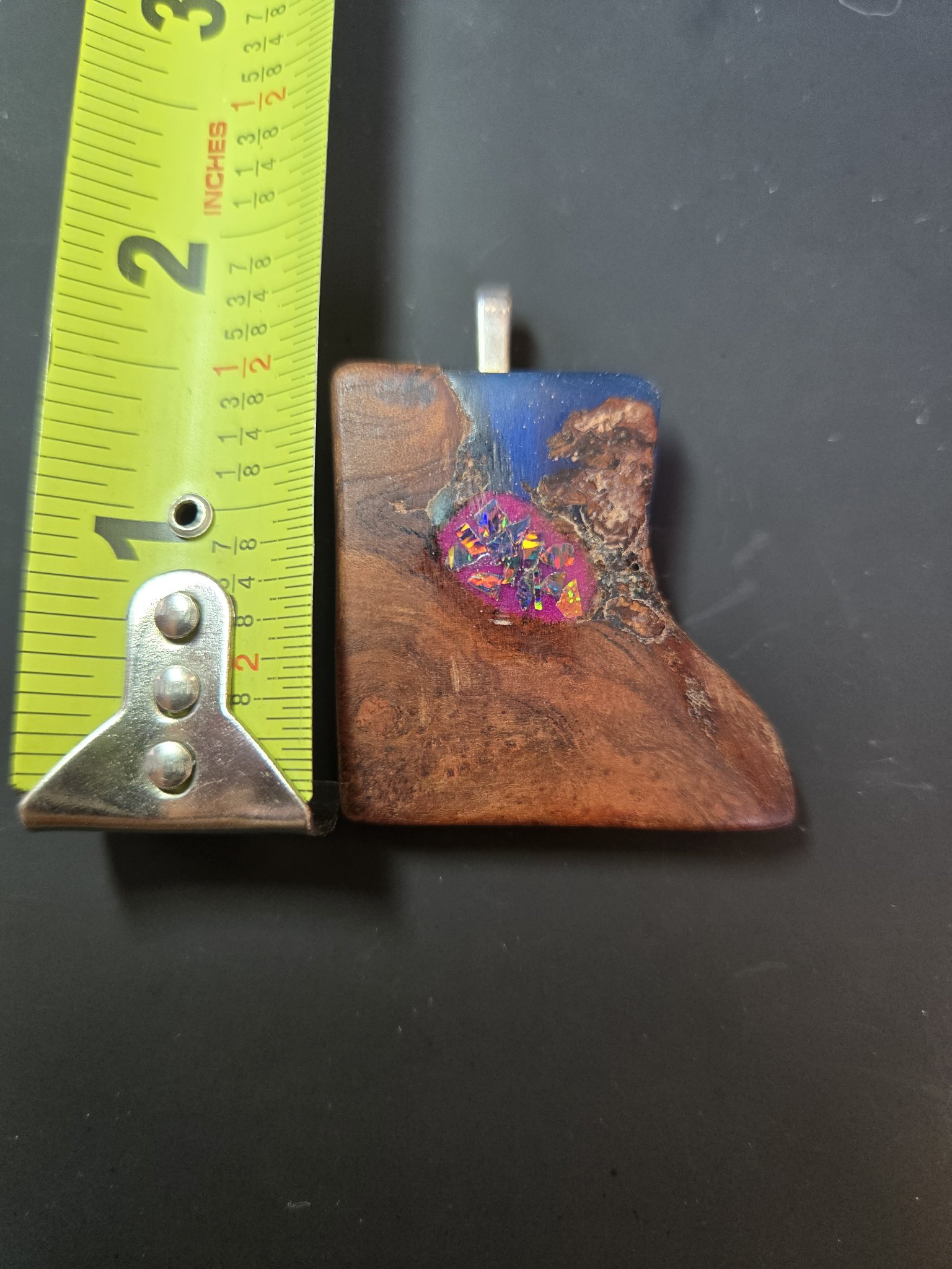 Maple blue resin and glow opal pendant beside a tape measure showing its height