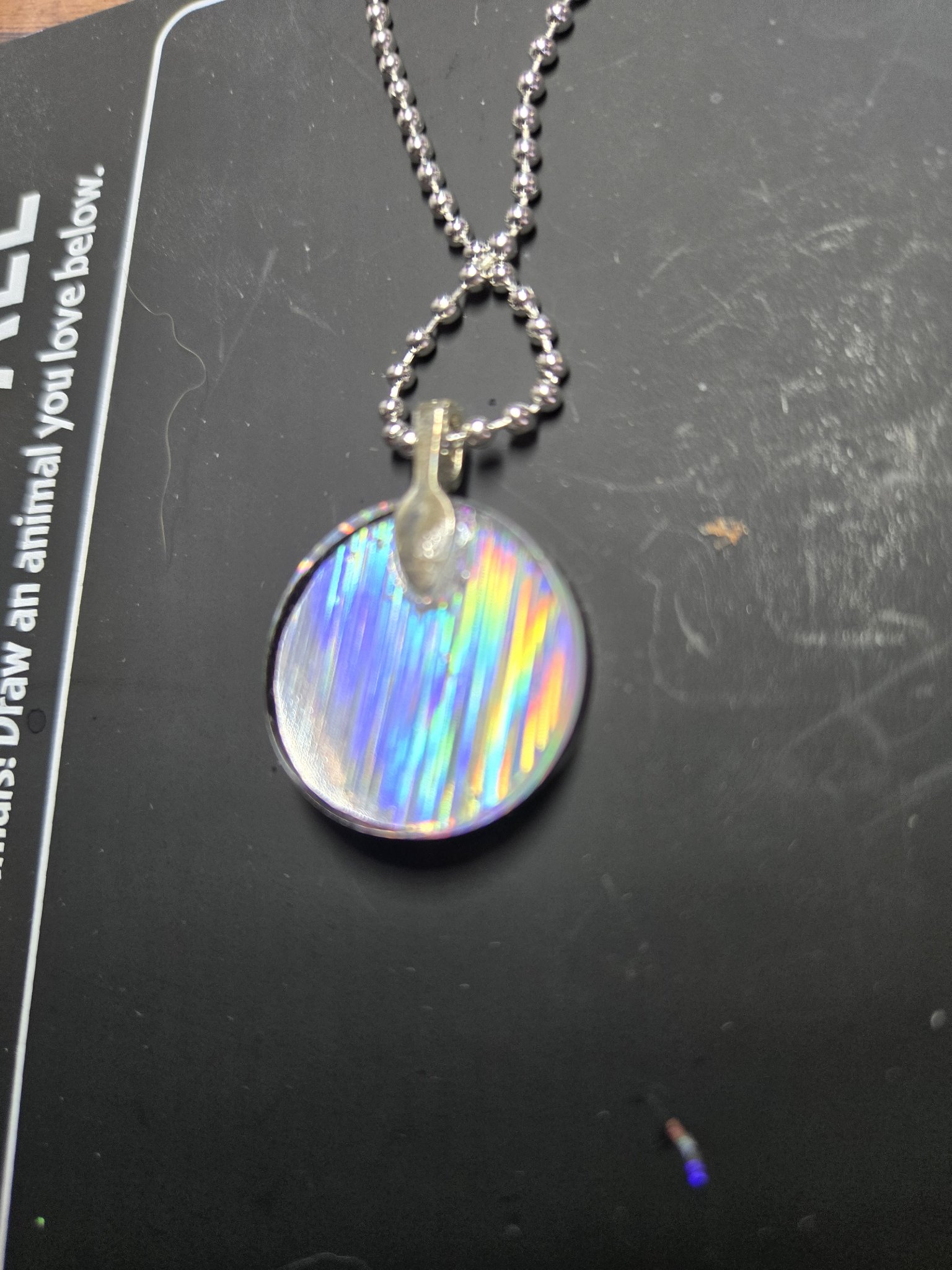 Rainbow side of the two-sided round holographic resin pendant