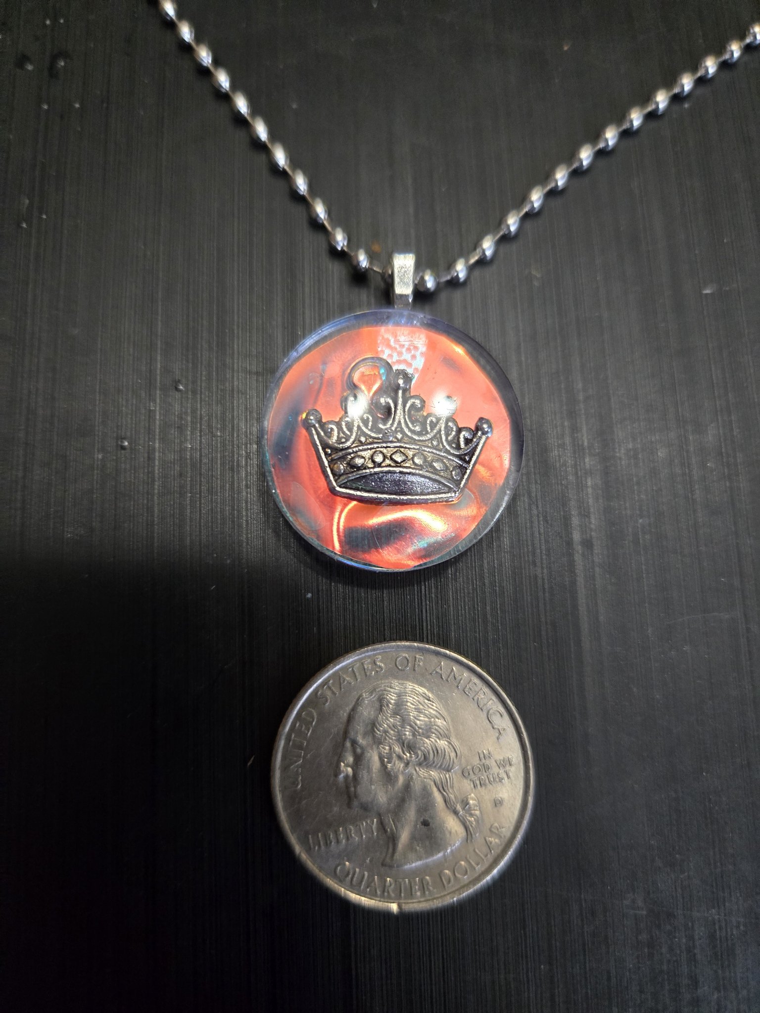 Stock 146 holographic resin crown pendant beside a quarter showing it is approximately one and a half inches across