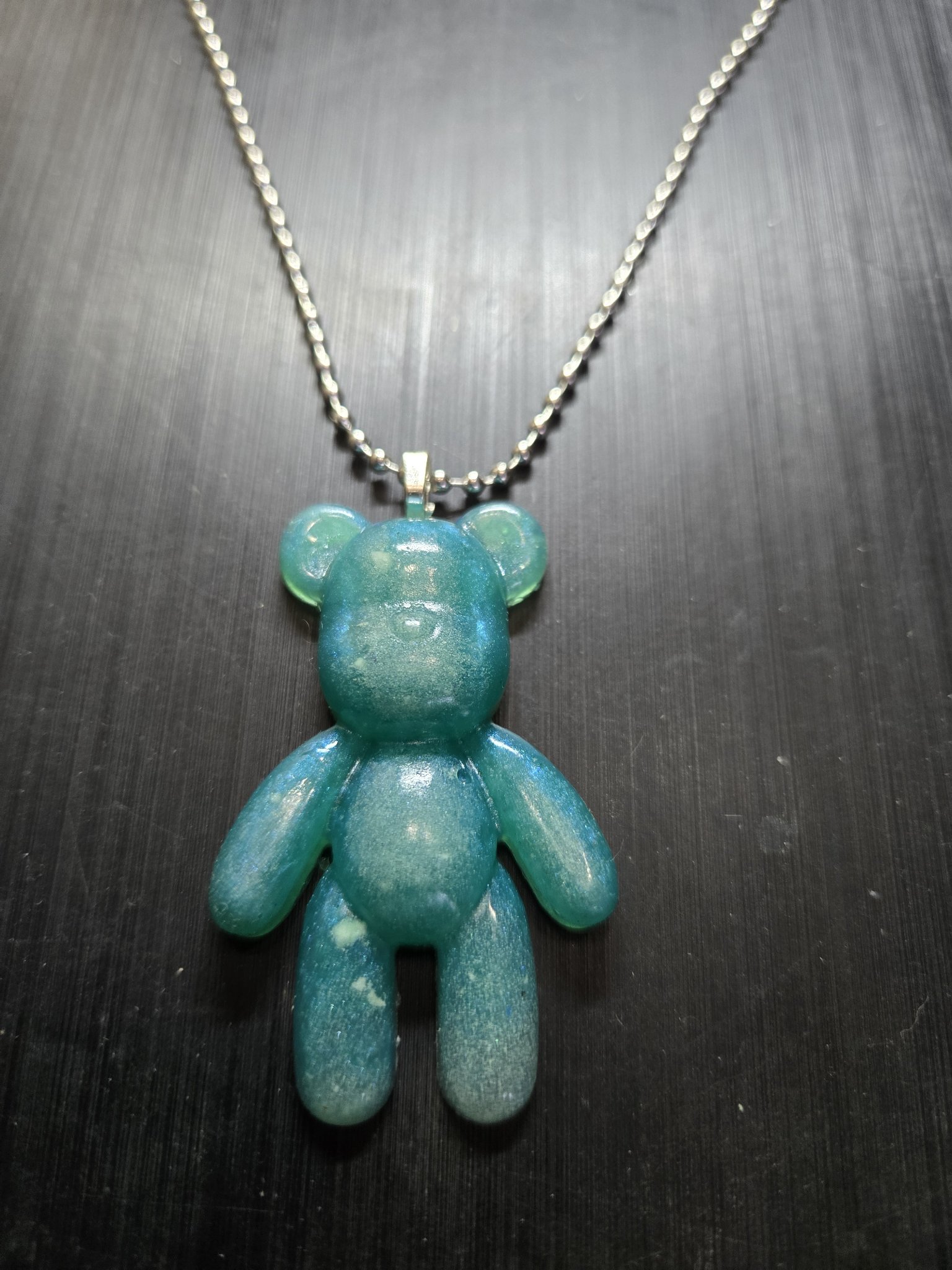 Stock 155 blue and green glow-in-the-dark resin teddy bear pendant on its 22-inch ball chain