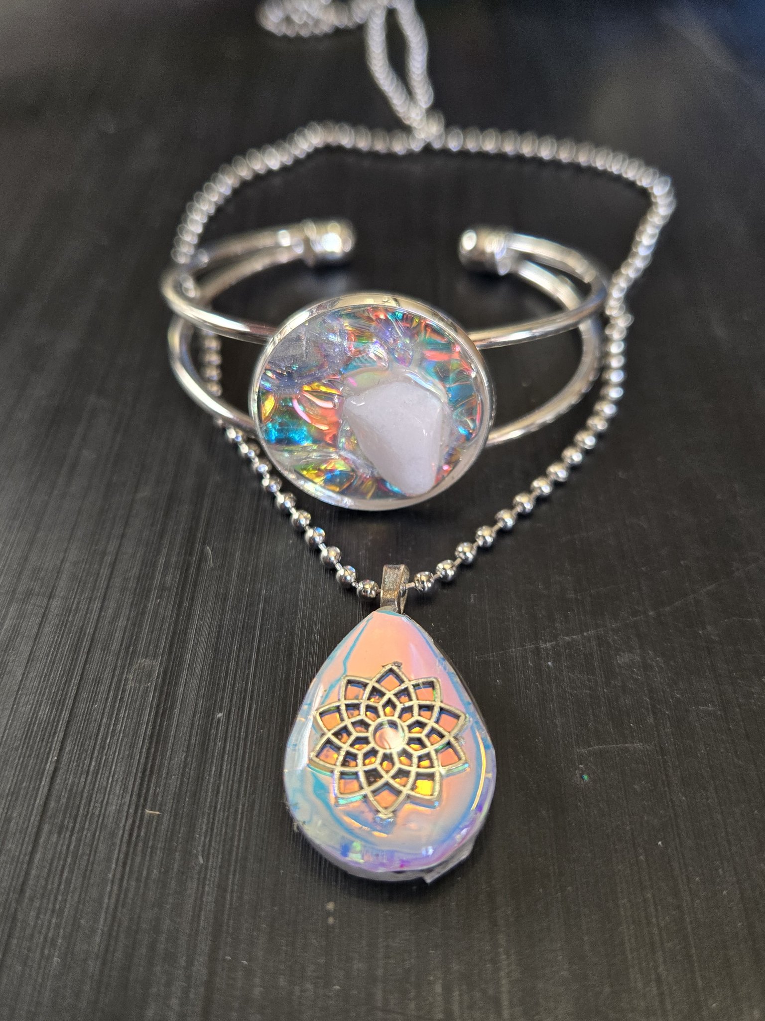 Alternate angle of both pieces in stock 184, the holographic bracelet and pendant set
