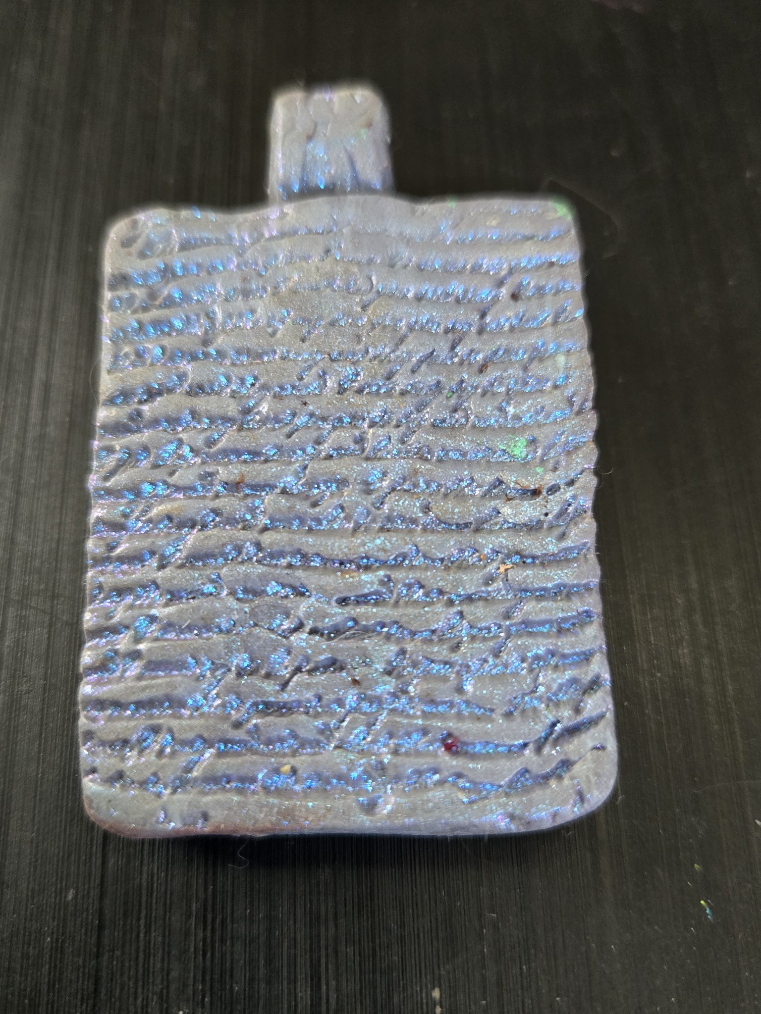 Textured script-pattern back of stock 189, the two-sided blue-pink mica polymer clay pendant