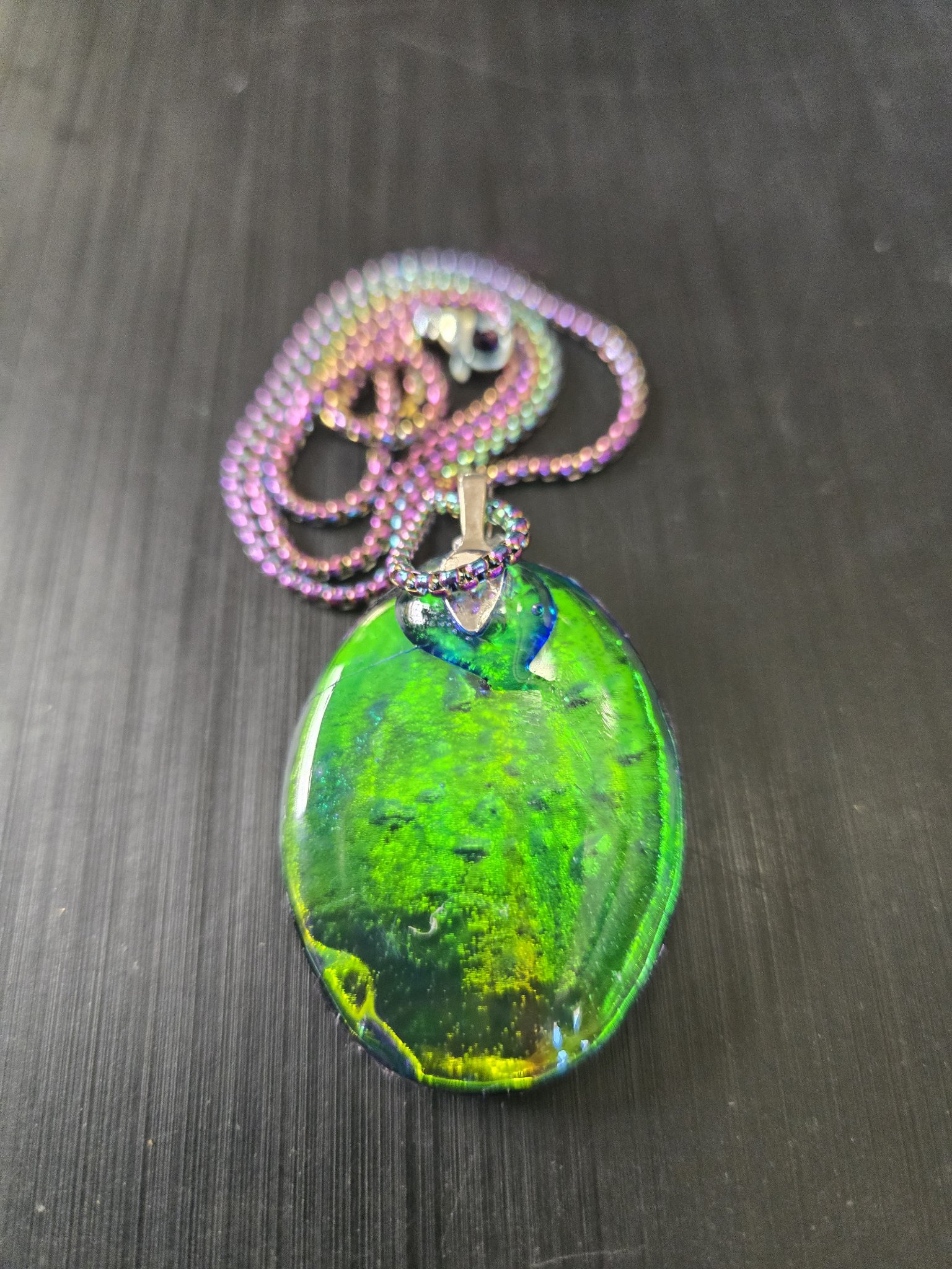 Holographic back of stock 193 oval branch and leaf resin pendant