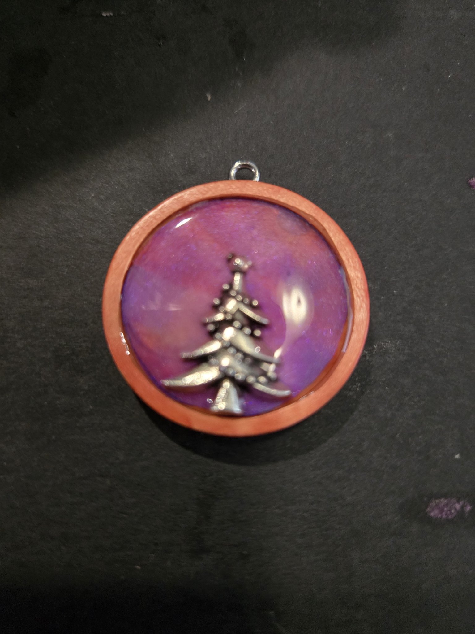 Stock 196 round Christmas tree pendant set on wood with resin and a silver-tone Christmas tree charm