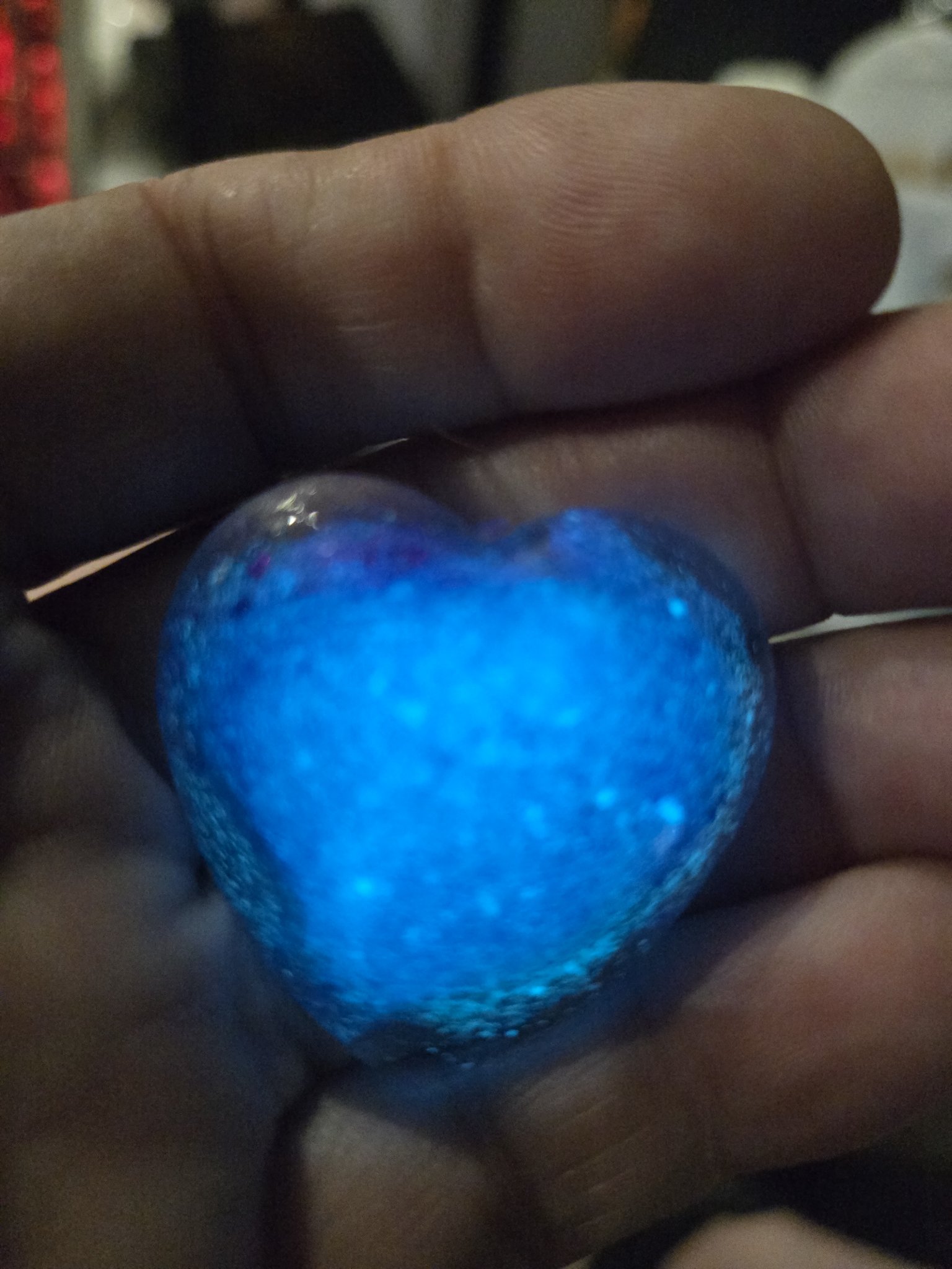 Alternate view of stock 197 heart-shaped resin pendant glowing blue in the dark