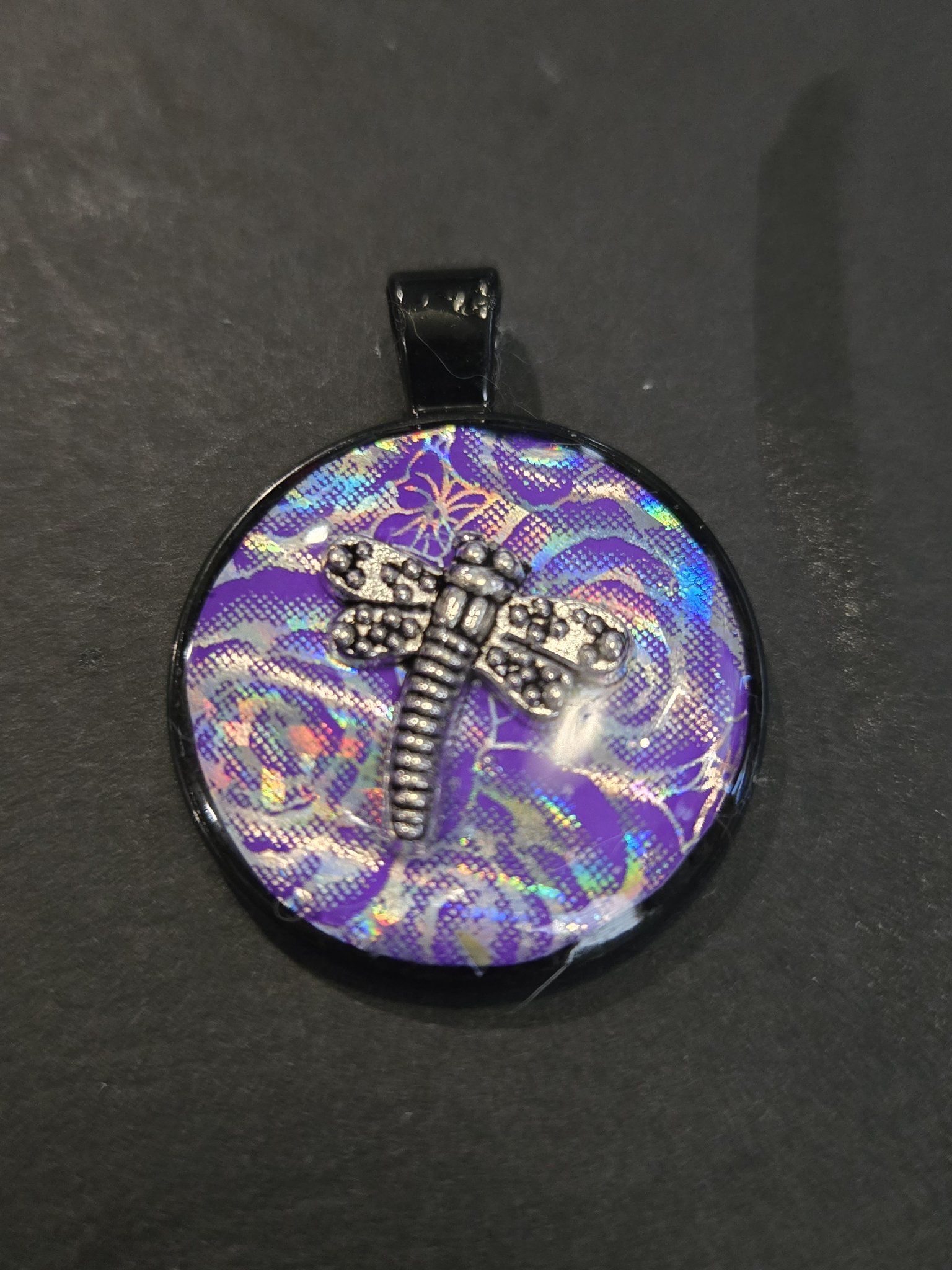 Stock 206 purple holographic floral resin pendant with a silver-tone dragonfly charm in a black metal frame, shown from the front
