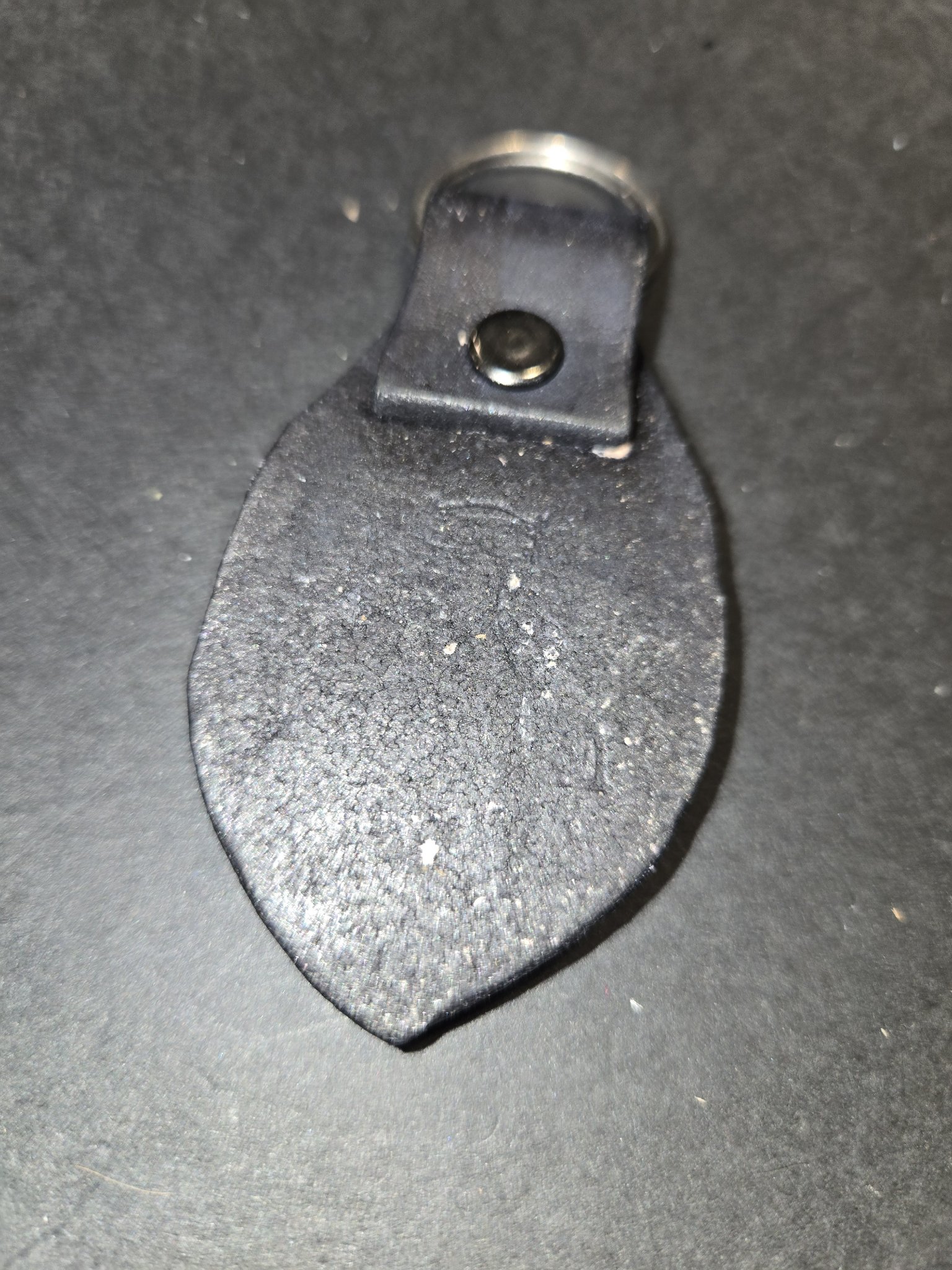 Back of stock 236 showing the antiqued black leather and the riveted loop holding the split key ring