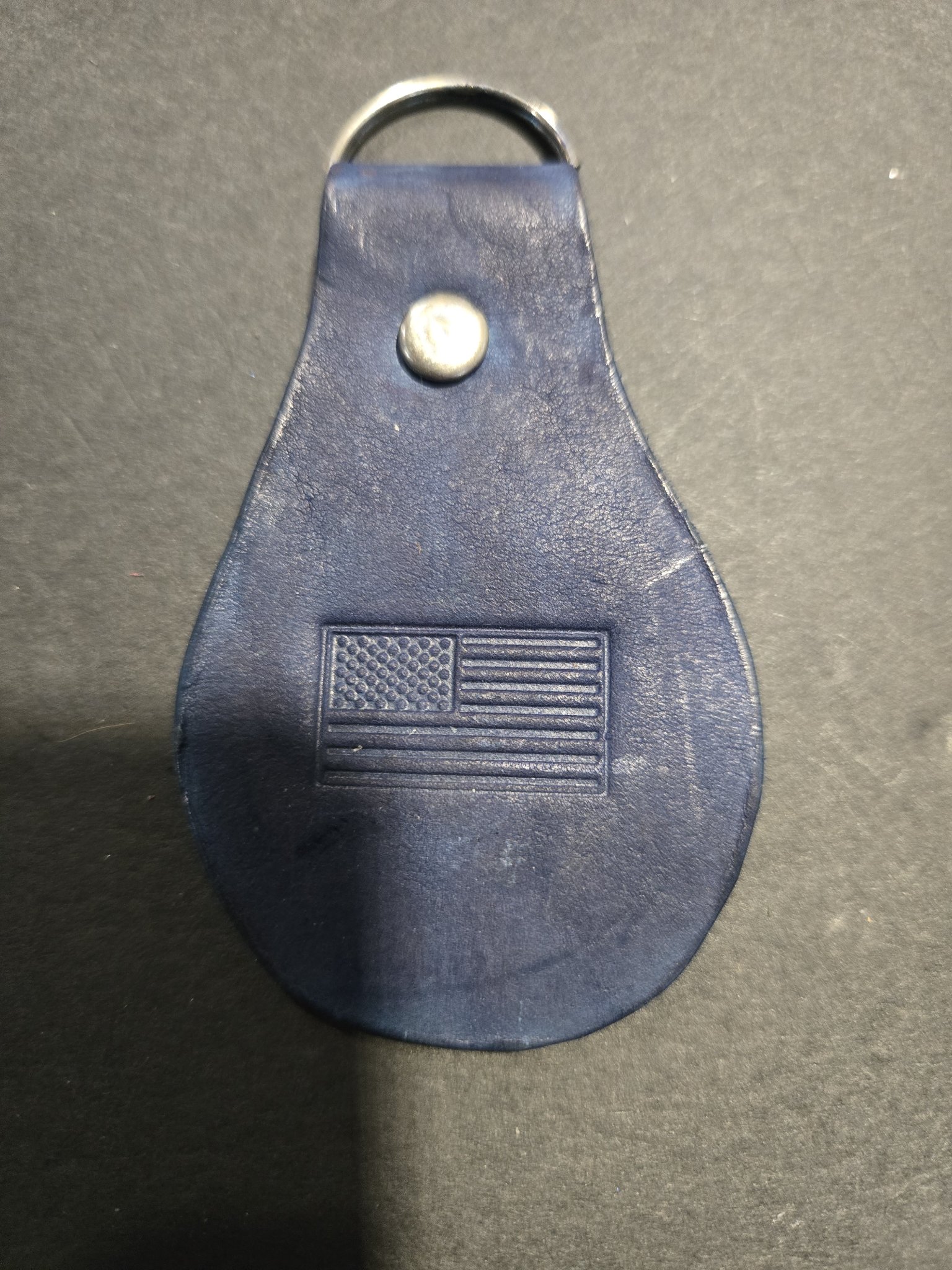 Stock 239 dark blue leather keychain with an embossed American flag, shown with its silver-tone rivet and split key ring