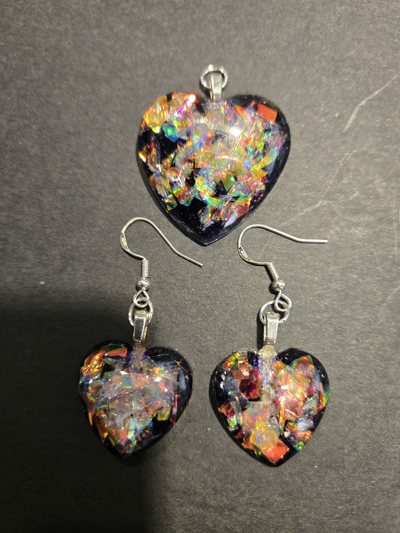 Stock 248 holographic heart earrings and pendant set from a second angle, showing the rainbow sparkle in all three hearts