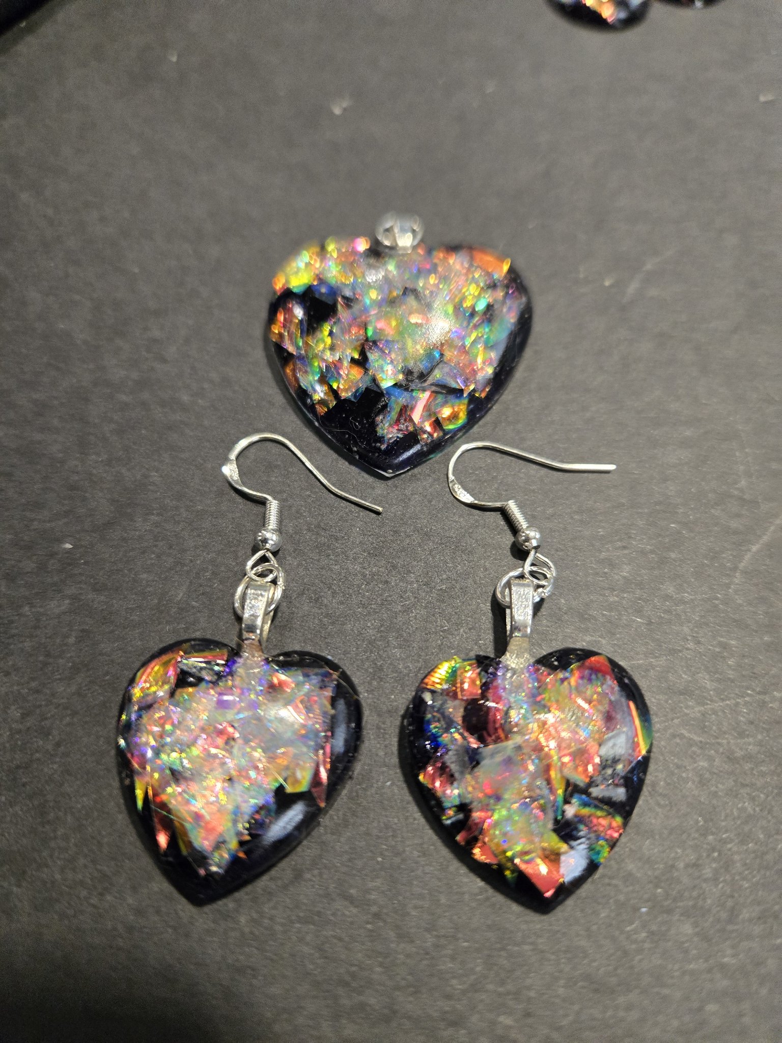 Another view of the stock 248 holographic heart earrings and pendant set, the hearts flashing rainbow colors