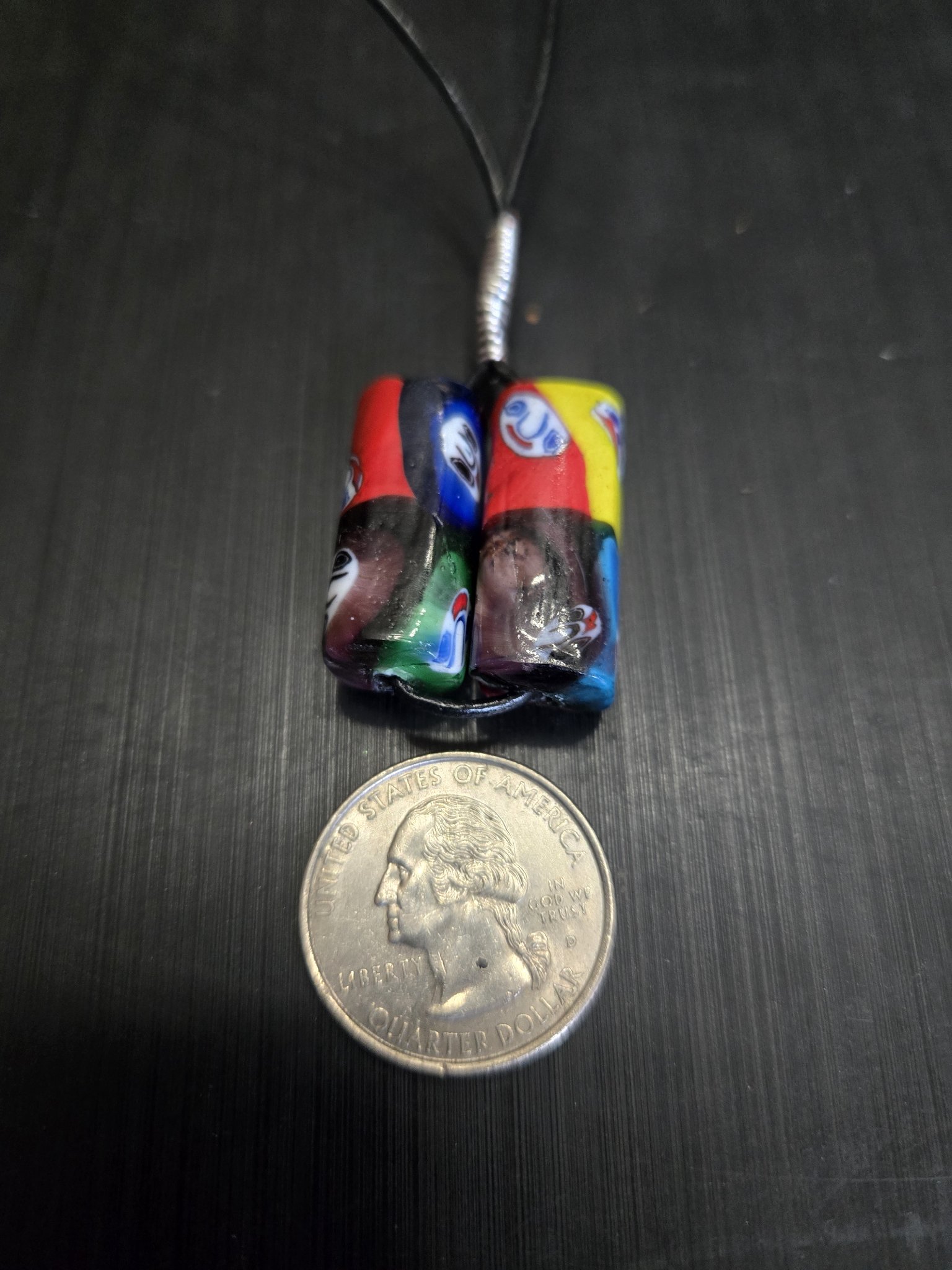 Stock 145 decorative handmade bead necklace beside a quarter for scale