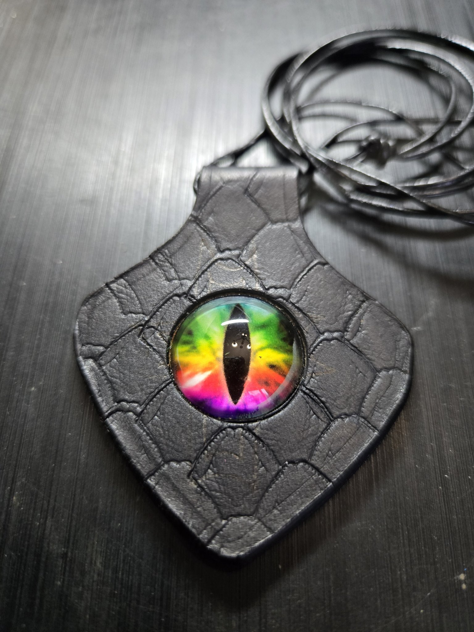 Stock 156 black dragon-scale-stamped leather pendant with rainbow dragon eye on its 30-inch black leather cord necklace