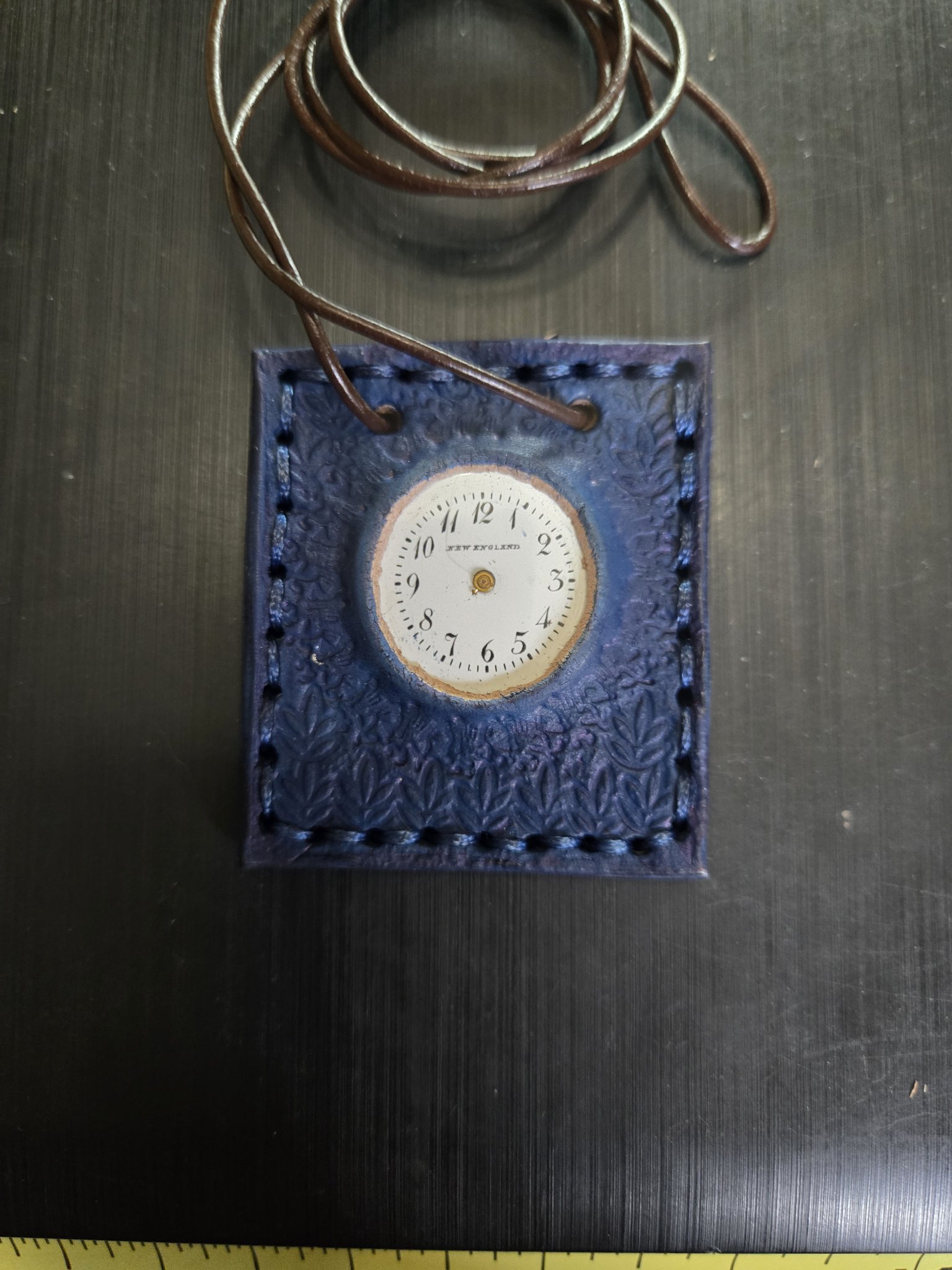 Stock 163 hand-sewn and hand-stamped blue leather pendant with a vintage New England clock face and 32-inch brown leather cord necklace