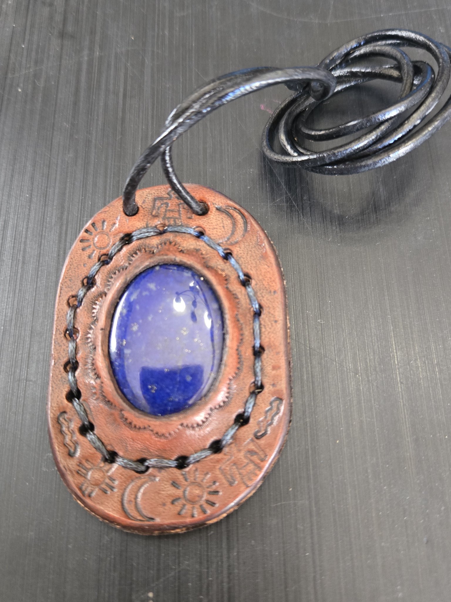 Front view of stock 181 hand-sewn lapis leather pendant with its 26-inch black leather cord necklace
