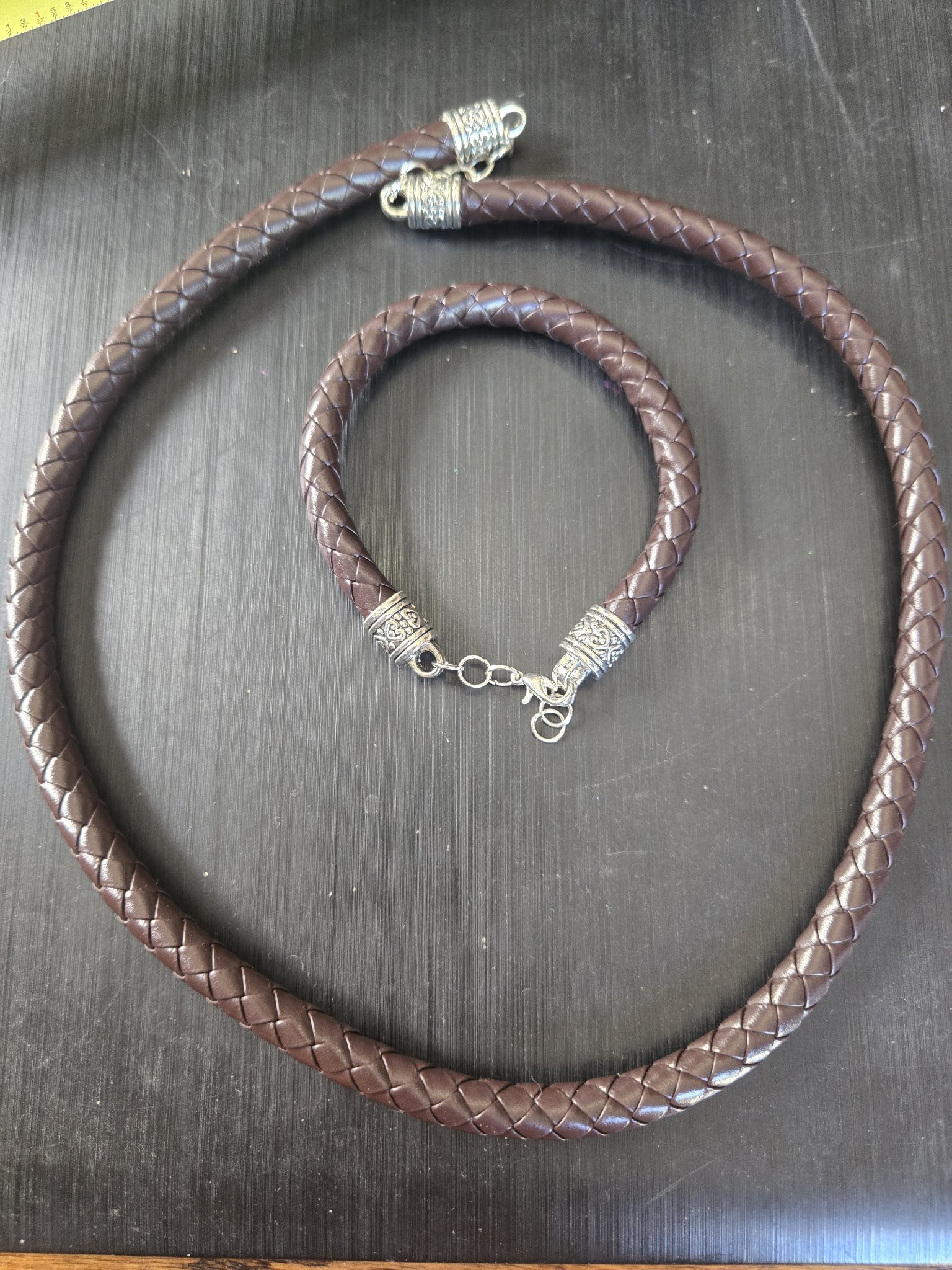 Stock 194 braided brown leather necklace and matching bracelet set with silver-tone heart-pattern end caps