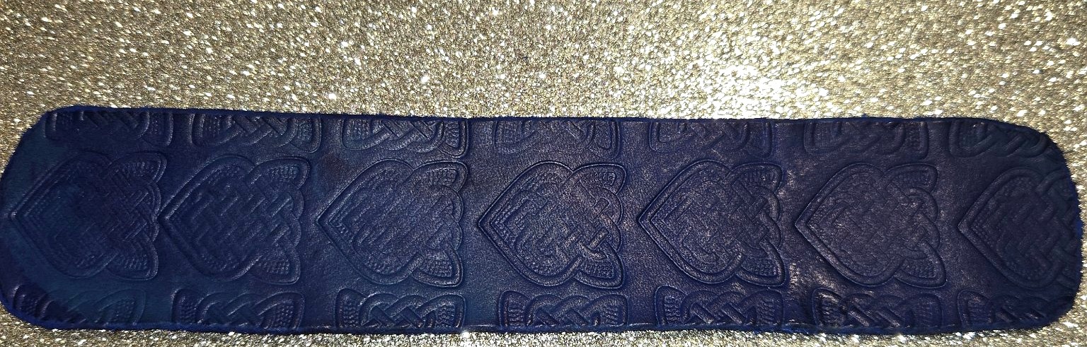Stock 211 blue leather cuff with repeated Celtic knot stamping, shown in full