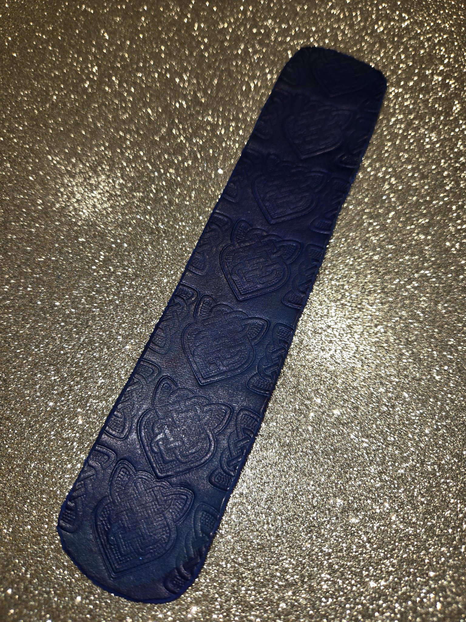 Close-up of the Celtic knot pattern stamped into stock 211 blue leather cuff