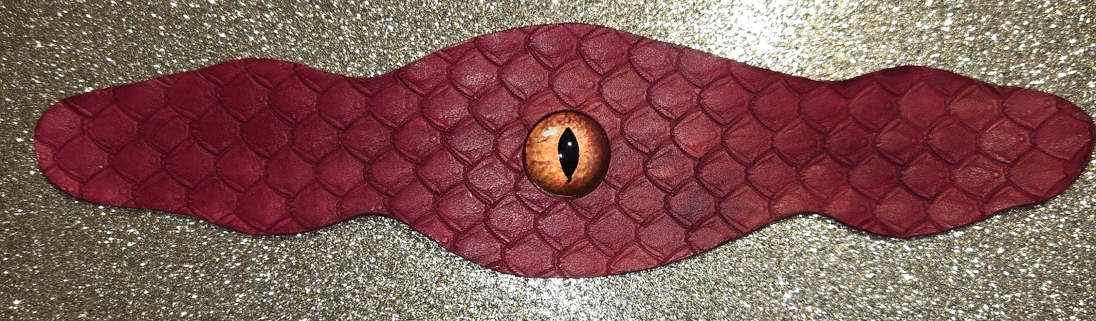 Stock 212 red leather cuff with dragon scale stamping and a dragon eye centerpiece, shown in full