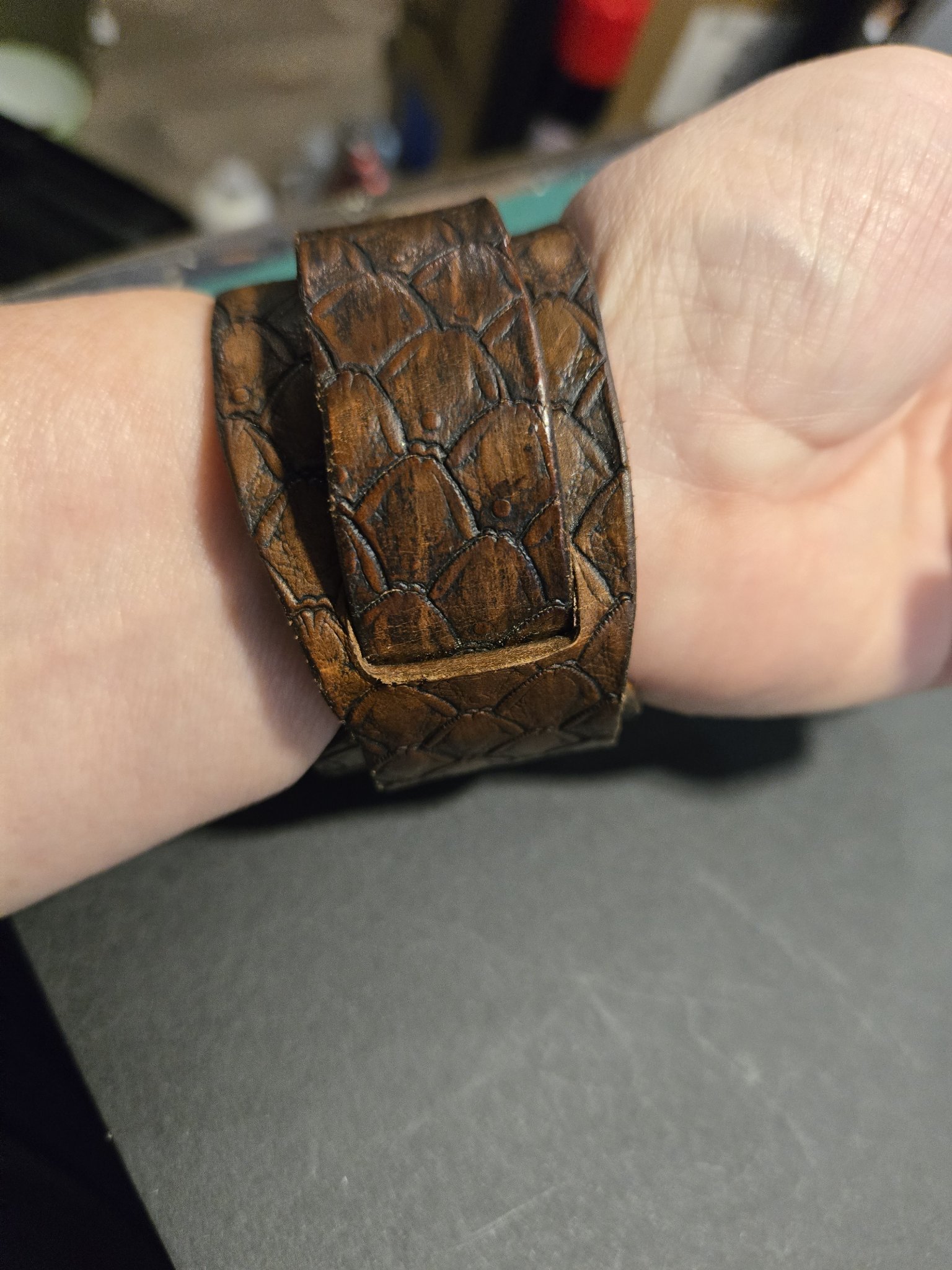 Back view of stock 214 showing the hand-stamped dragon scale pattern around the leather cuff