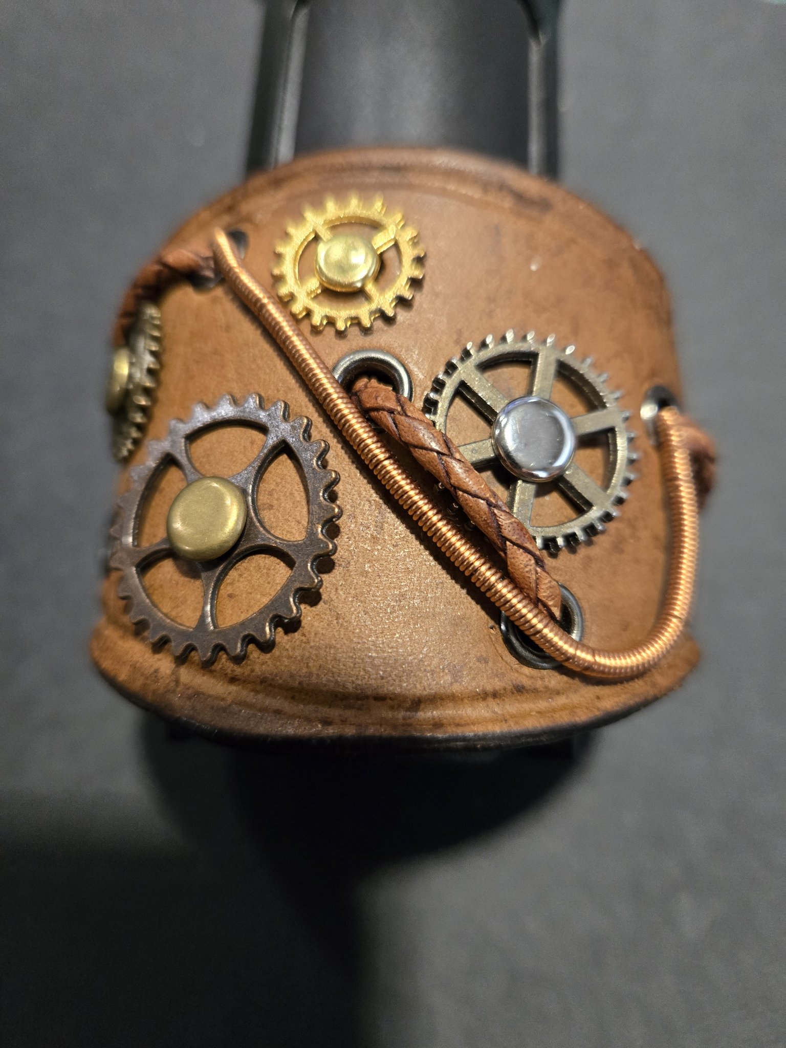 Stock 215 standing upright to show the brown leather, working gears, braided leather, and copper-colored wire details