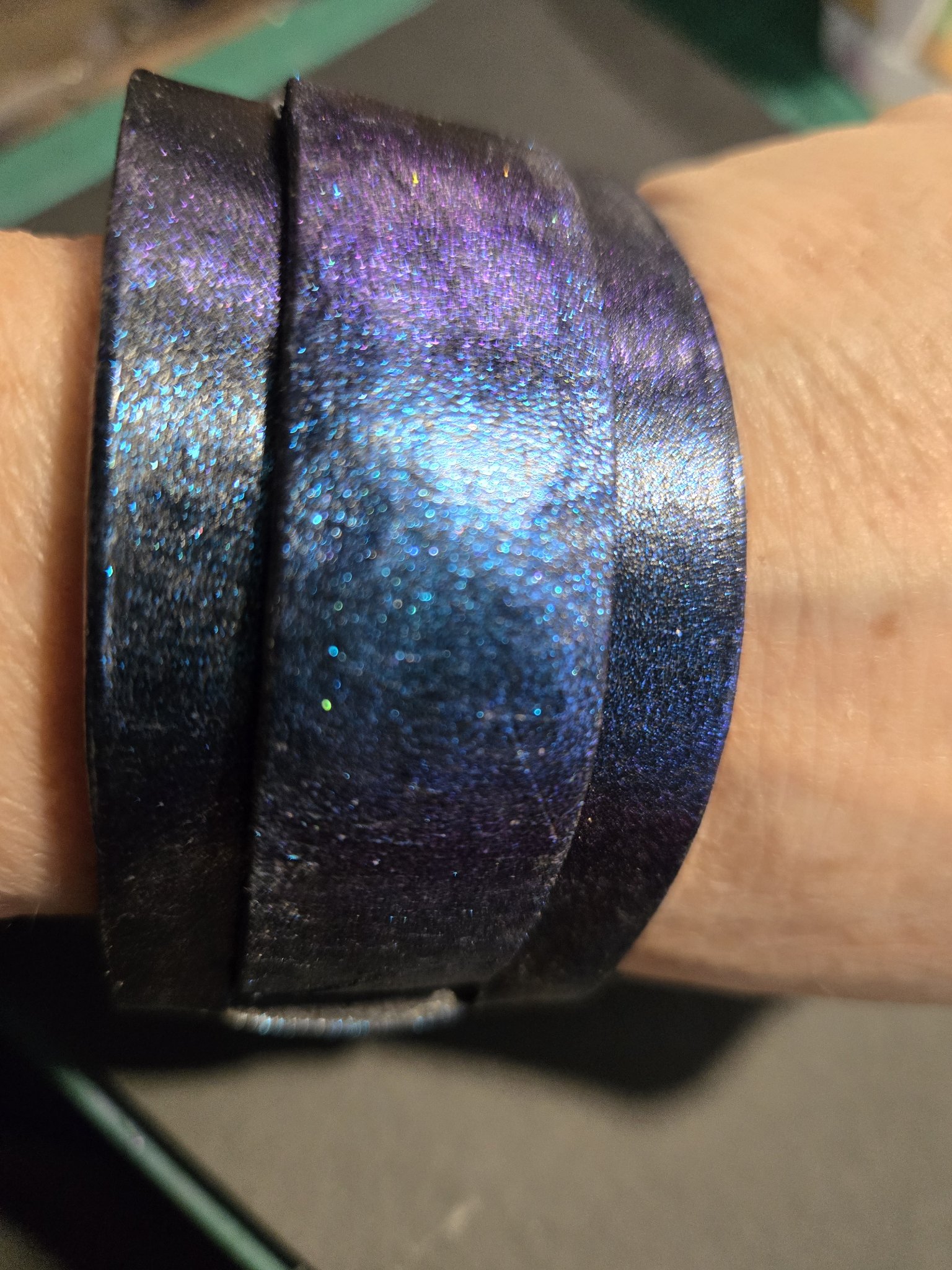Angled wrist view of stock 216 showing its blue-to-purple color shift