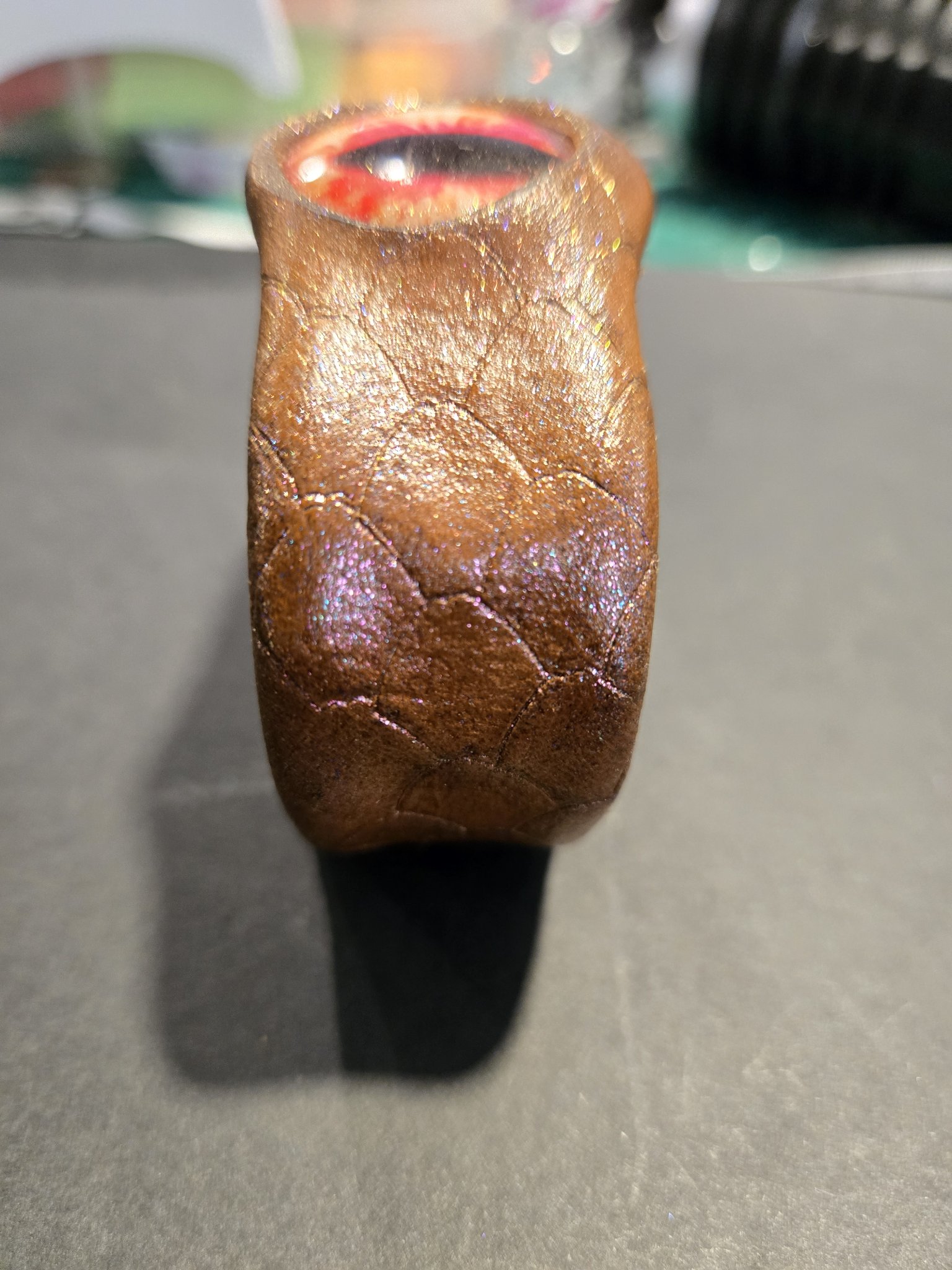 Side view of stock 218 showing the dragon scale texture and pinkish sheen
