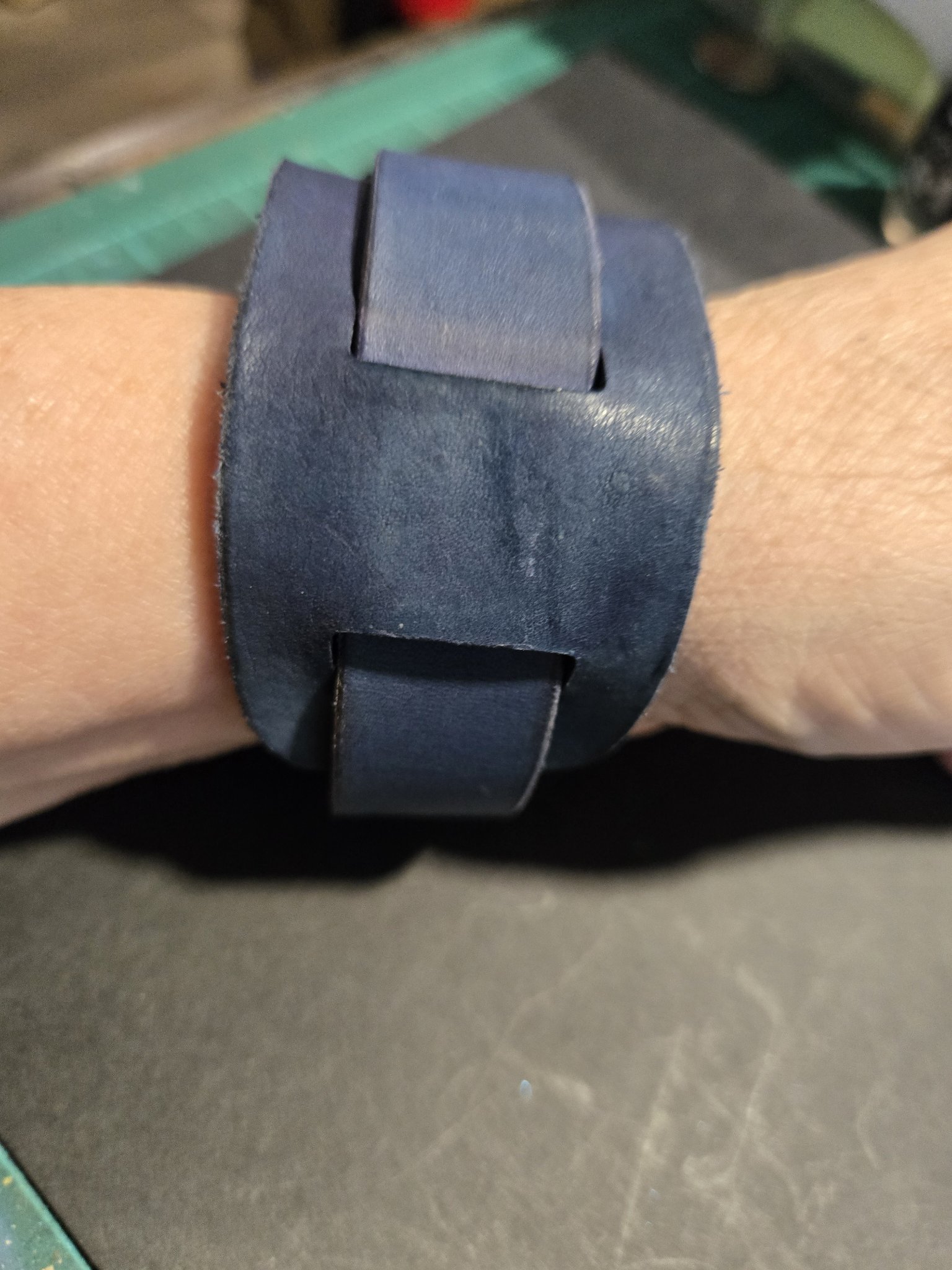 Close-up of stock 225 on a wrist showing the layered leather wrap design