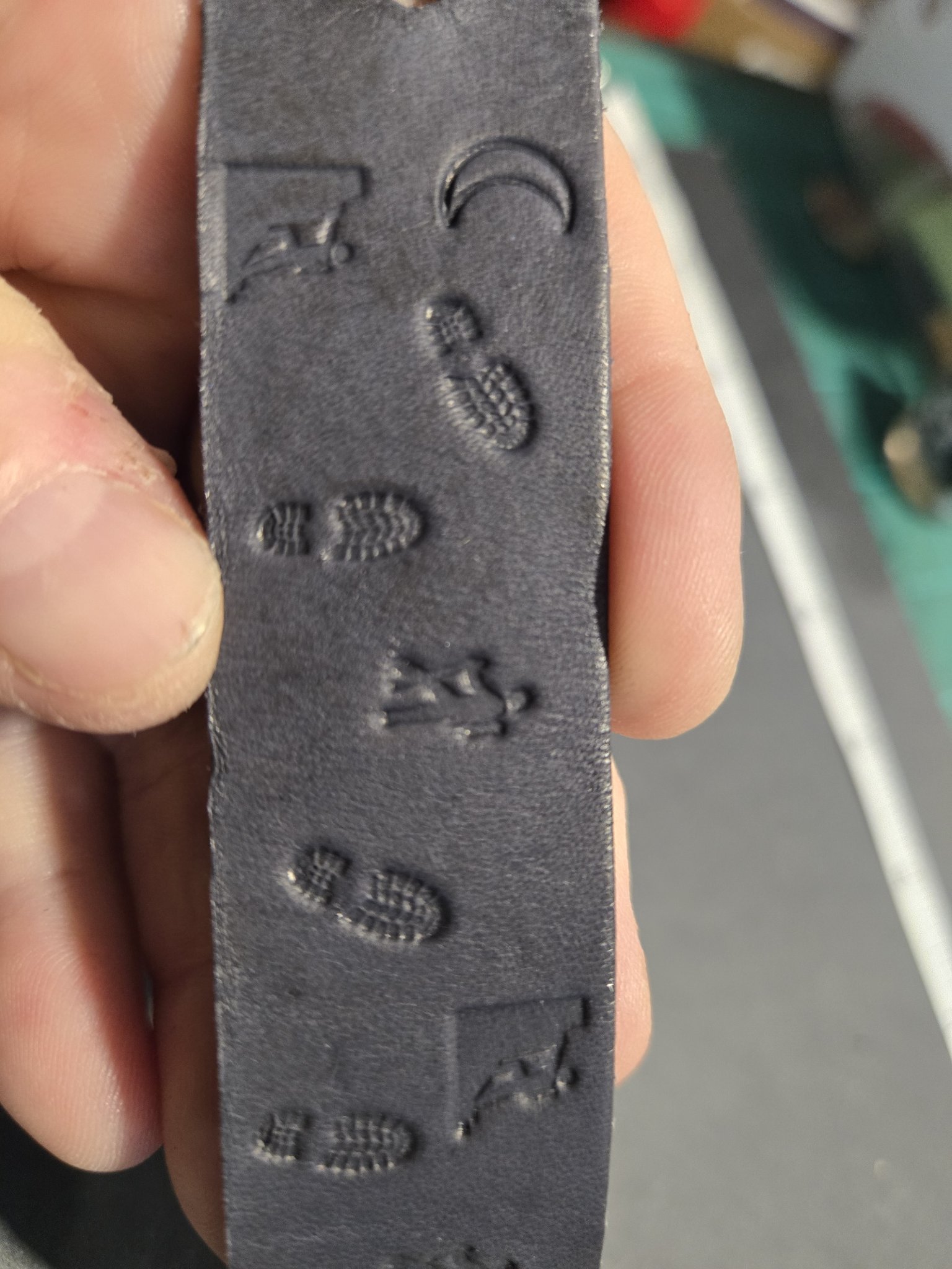 Close-up detail of stock 228 showing the stamped hiker, crescent moon, and boot prints