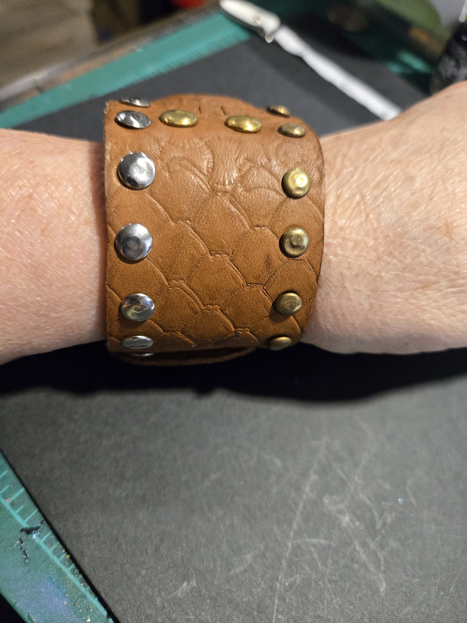 Stock 231 on a wrist showing the studded dragon scale pattern band