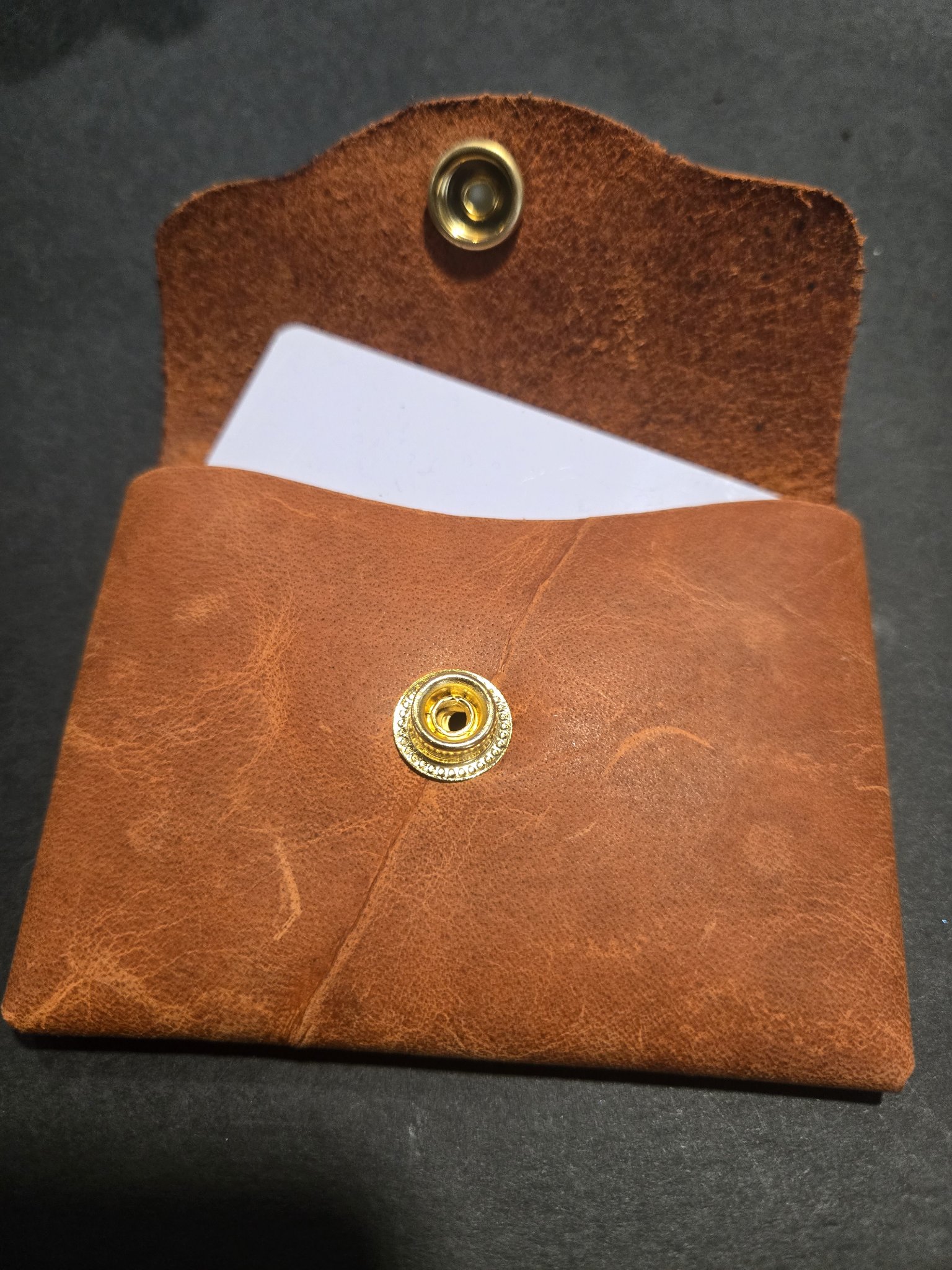 Stock 245 open with a card tucked inside, shown for size only, and the brass snap closure